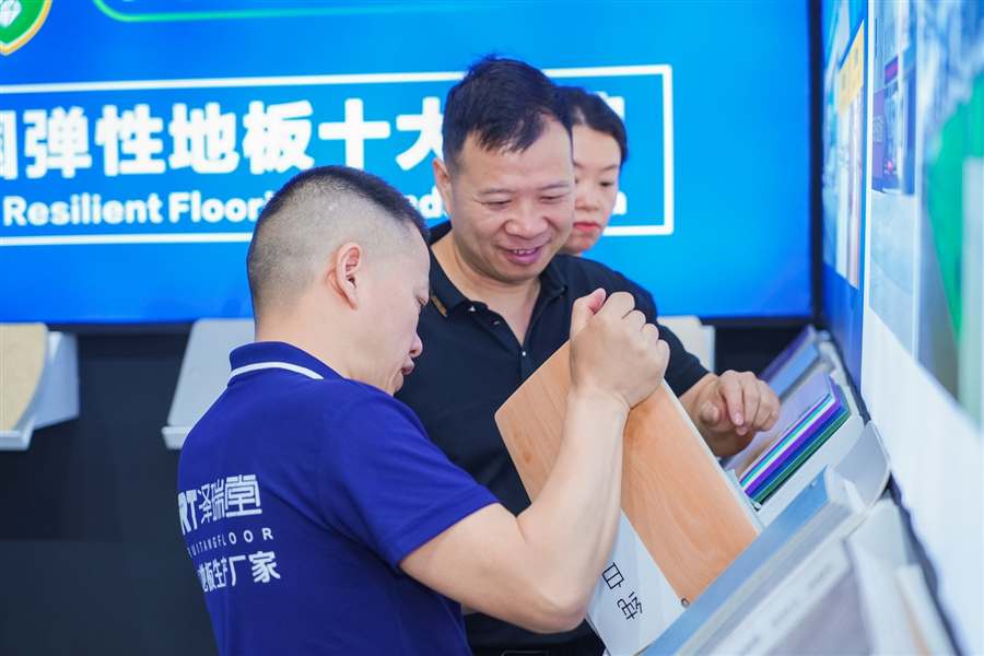 Visitors reviewing ZRT flooring samples
